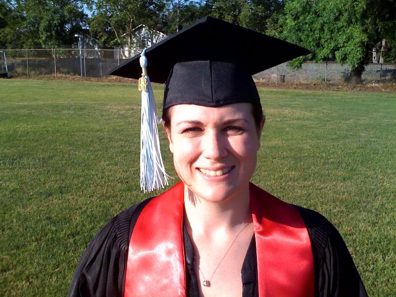 A young woman in a cap and gown on graduation day